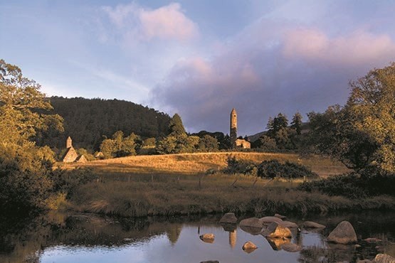 Glendalough round tower from across the lake