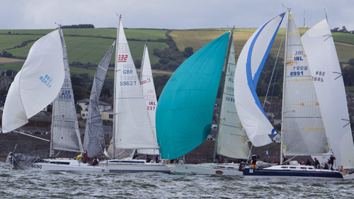 Multiple boats are making their way through sea in breezy weather